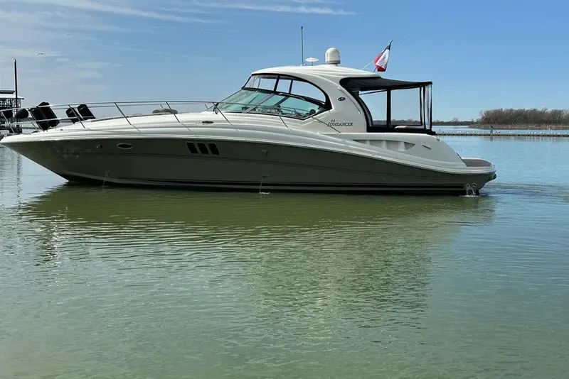 Slide: The Image of 2006 Sea Ray 44 Sundancer yacht on calm water under clear sky. - 3