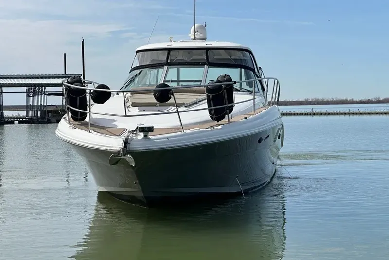 Slide: The Image of 2006 Sea Ray 44 Sundancer yacht on calm water, front view. - 9