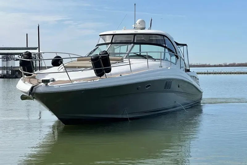 Slide: The Image of 2006 Sea Ray 44 Sundancer yacht on calm water, clear sky background. - 8