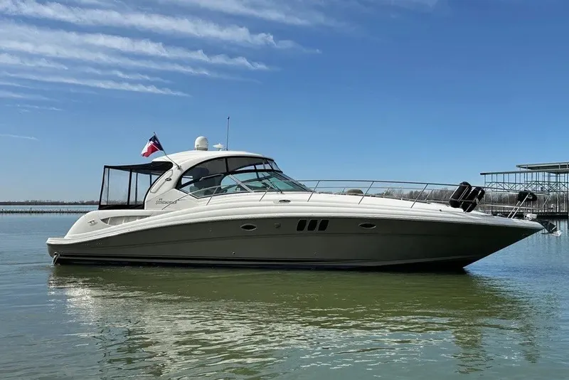 Slide: The Image of 2006 Sea Ray 44 Sundancer yacht on calm water under clear blue sky. - 15