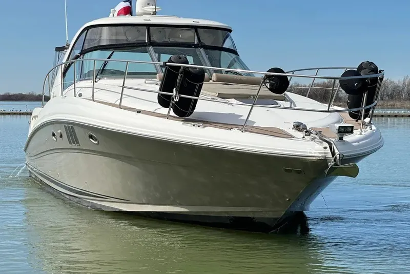 Slide: The Image of 2006 Sea Ray 44 Sundancer yacht on calm water, showcasing sleek design and luxury features. - 18