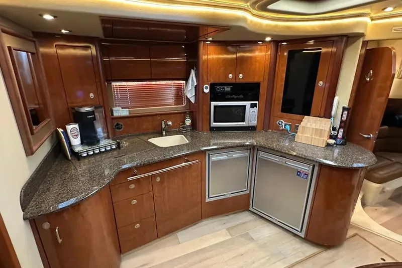 Slide: The Image of Luxurious kitchen interior of 2006 Sea Ray 44 Sundancer yacht with modern amenities. - 22