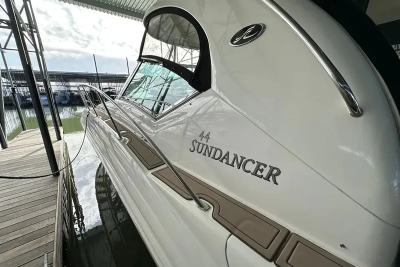 Slide: The Image of 2006 Sea Ray 44 Sundancer yacht docked, showcasing sleek design and elegant branding. - 42
