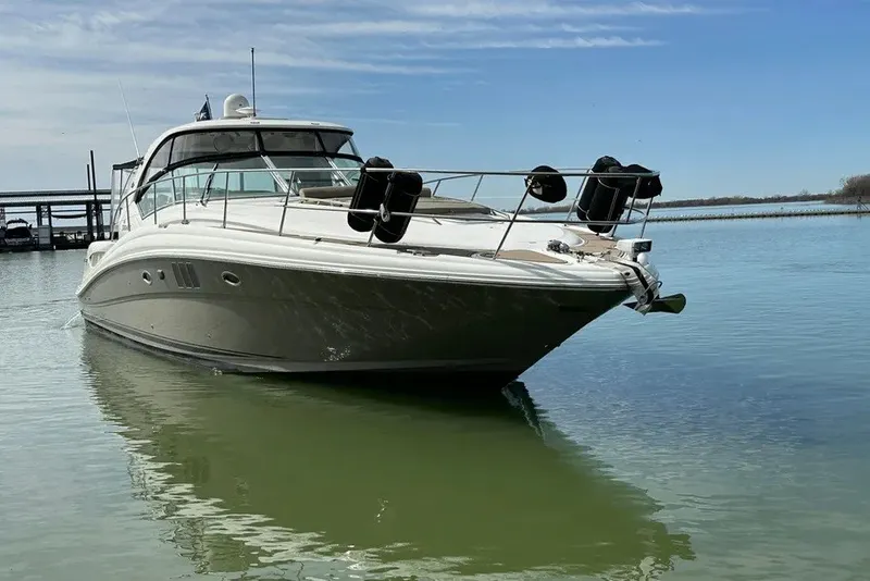 Slide: The Image of 2006 Sea Ray 44 Sundancer yacht on calm water under blue sky. - 11