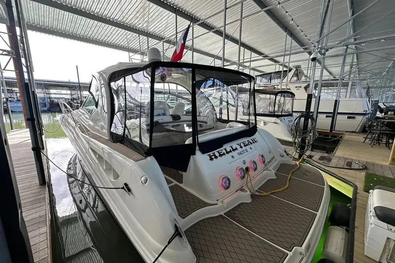 Slide: The Image of 2006 Sea Ray 44 Sundancer docked in a covered marina, rear view. - 38