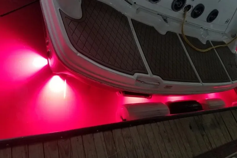 Slide: The Image of 2006 Sea Ray 44 Sundancer with vibrant pink underwater lights at the stern. - 48