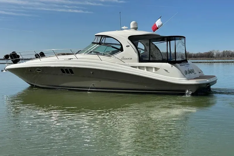 Slide: The Image of 2006 Sea Ray 44 Sundancer yacht on calm water, side view with clear sky. - 1