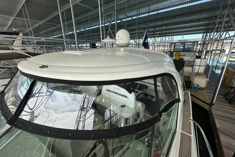 Slide: The Image of 2006 Sea Ray 44 Sundancer yacht docked under a covered marina. - 39