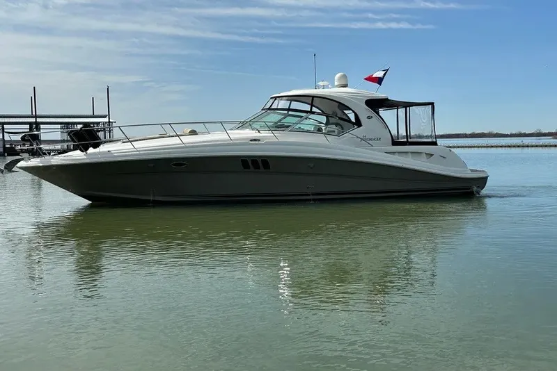 Slide: The Image of 2006 Sea Ray 44 Sundancer yacht on calm water under a clear sky. - 5