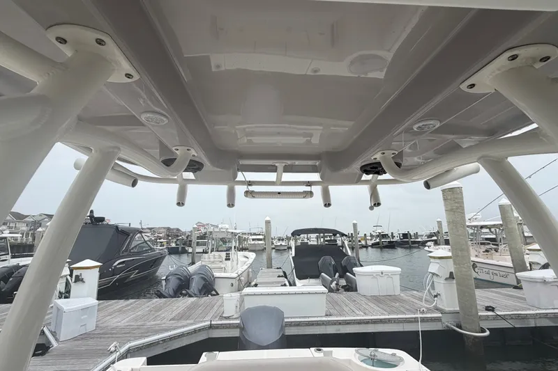 Slide: The Image of Seaborn SX 239 boat docked at marina, showcasing interior and overhead structure, 2021 model. - 16