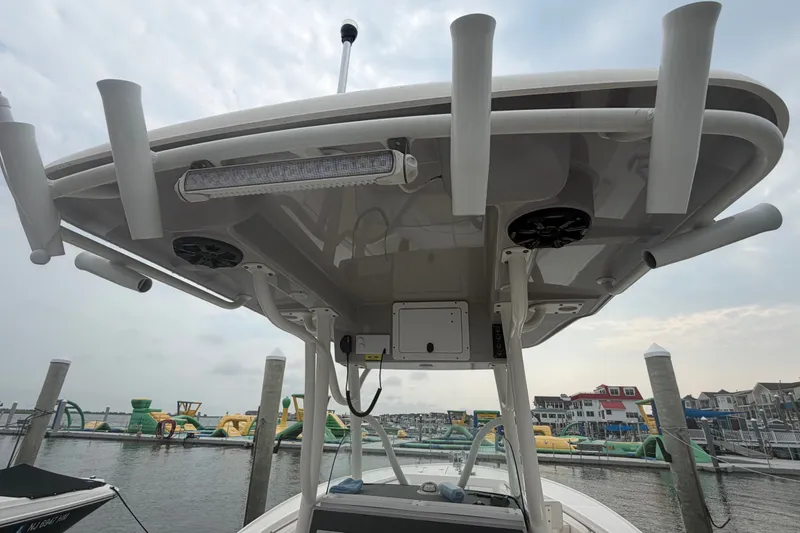 Slide: The Image of 2021 Seaborn SX 239 boat with T-top and rod holders at marina. - 21