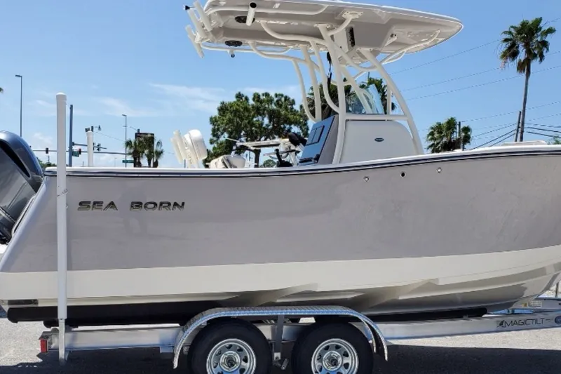 Slide: The Image of 2021 Seaborn SX 239 boat on trailer, parked outdoors under clear sky. - 27