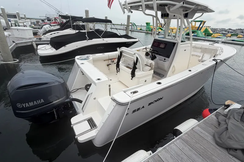 The Image of 2021 Seaborn SX 239 boat docked, featuring Yamaha outboard motor, in a marina setting. - 0