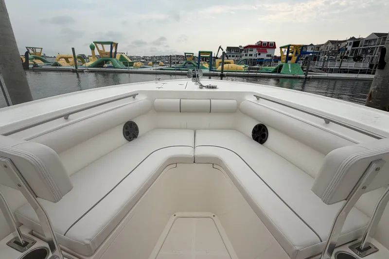 Slide: The Image of Interior view of 2021 Seaborn SX 239 boat with white seating, docked near inflatable water park. - 19