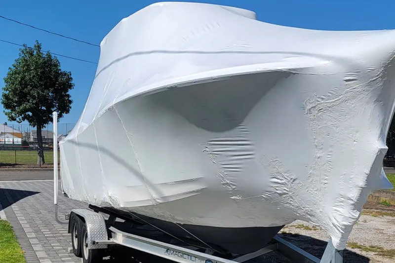 Slide: The Image of 2021 Seaborn SX 239 boat wrapped in protective cover on trailer. - 25