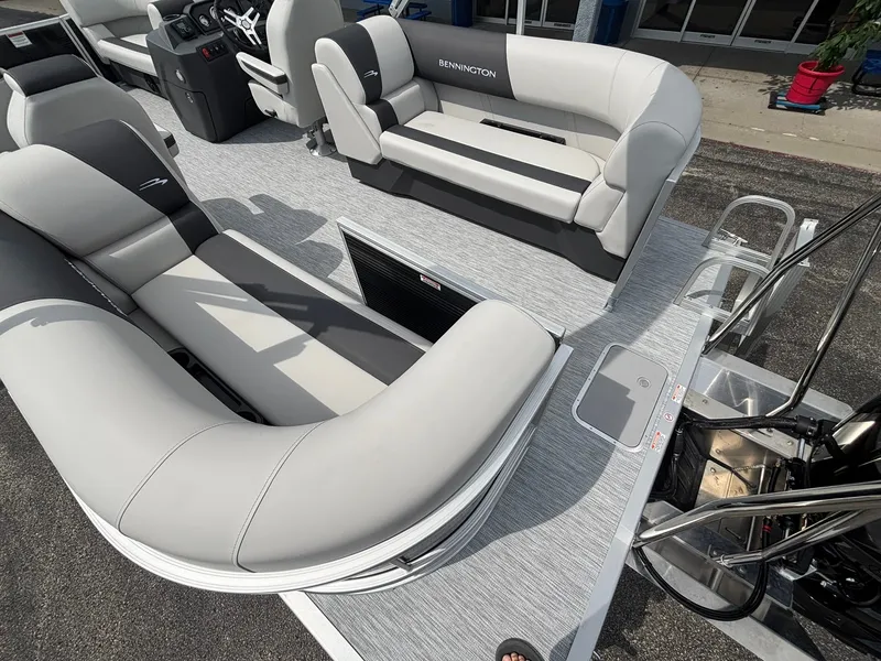 Slide: The Image of The image shows the deck of a Bennington 22 S1SR SPS pontoon boat with gray upholstered seating. - 32