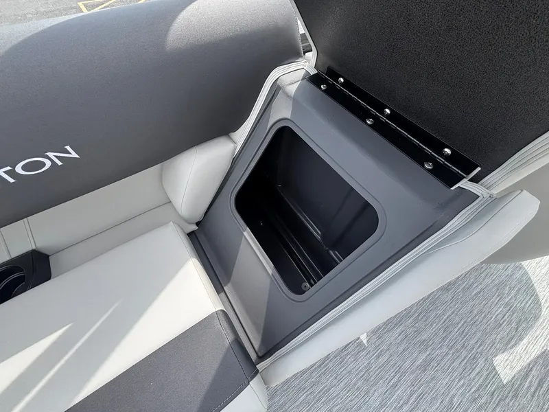 Slide: The Image of A seating area with an open storage compartment in a Bennington boat. - 29