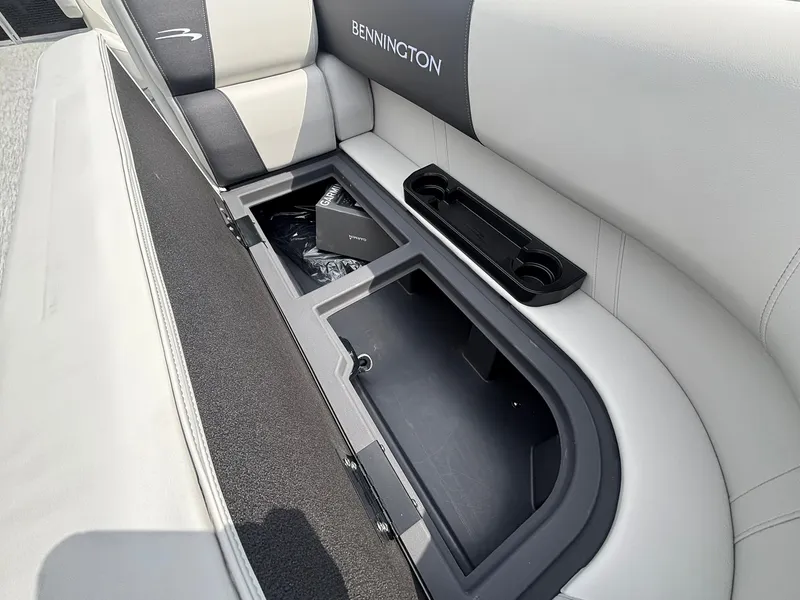 Slide: The Image of The 2027 Bennington 22 S1SR SPS features a cushioned bench seat with integrated storage and cup holders. - 14