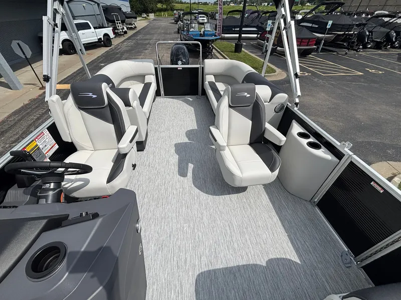 Slide: The Image of The image shows the spacious deck of a Bennington 22 S1SR SPS pontoon boat with luxurious seating. - 18