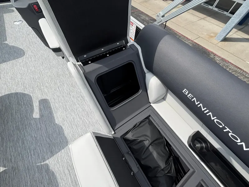 Slide: The Image of Interior of a Bennington 22 S1SR SPS with gray upholstery and storage compartments. - 27