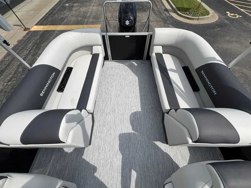Slide: The Image of The image shows the interior of a Bennington 22 S1SR SPS pontoon boat with gray and black seating. - 26