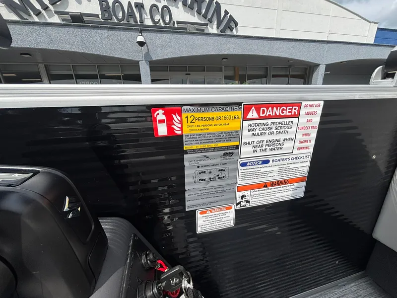 Slide: The Image of Warning labels and capacity information on a boat. - 24