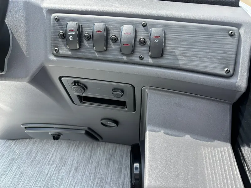 Slide: The Image of Close-up of the dashboard on a Bennington 22 S1SR SPS boat featuring several switches. - 22