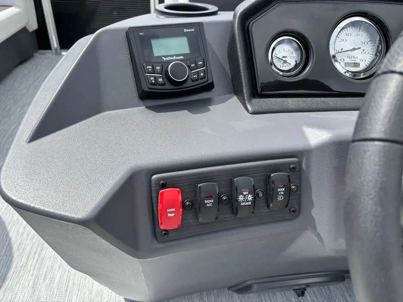 Slide: The Image of The image shows the dashboard of a Bennington 22 S1SR SPS boat with switches and gauges. - 20