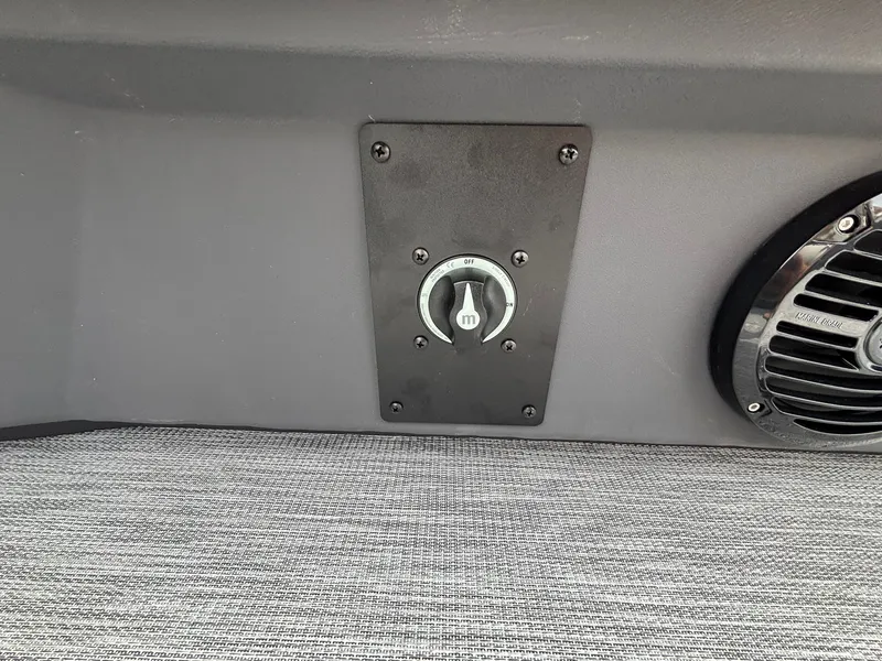 Slide: The Image of Close-up of a speaker and a switch on a gray boat carpet. - 31