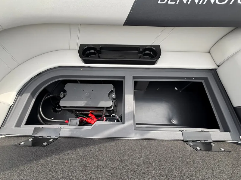 Slide: The Image of An open storage compartment on a Bennington boat reveals batteries and wiring. - 30