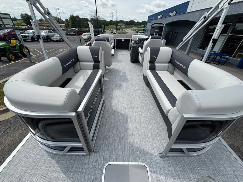 Slide: The Image of The image shows the spacious deck of a Bennington 22 S1SR SPS pontoon boat with gray and black seating. - 33
