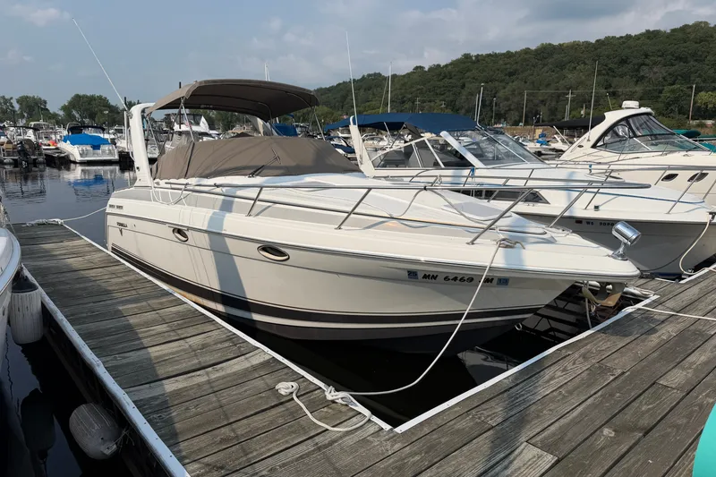 The Image of 2002 Formula 27 Performance Cruiser docked at a marina, surrounded by other boats. - 1