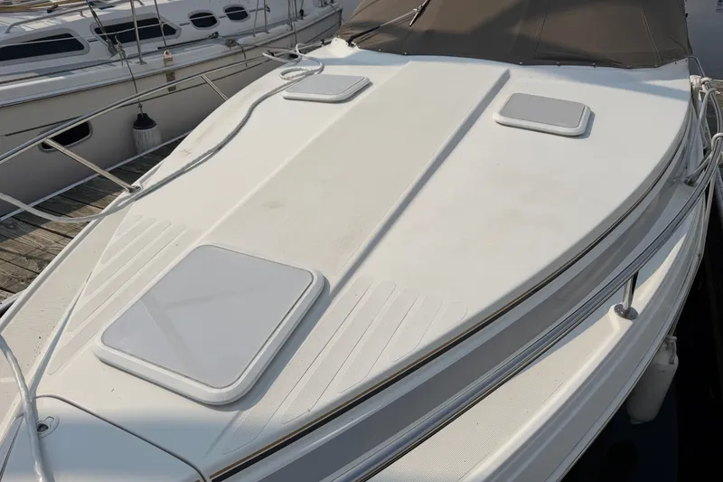 Slide: The Image of 2002 Formula 27 Performance Cruiser boat docked, showcasing sleek white deck design. - 3