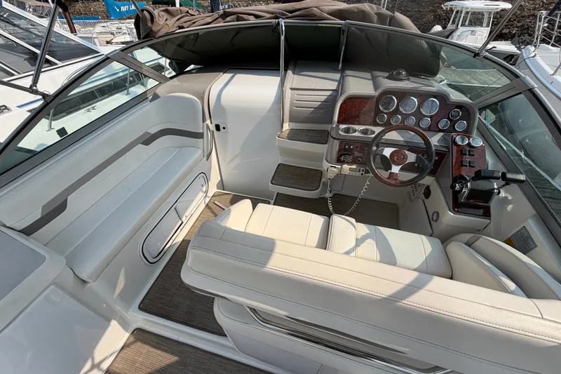Slide: The Image of 2002 Formula 27 Performance Cruiser cockpit with white seating and detailed dashboard. - 12