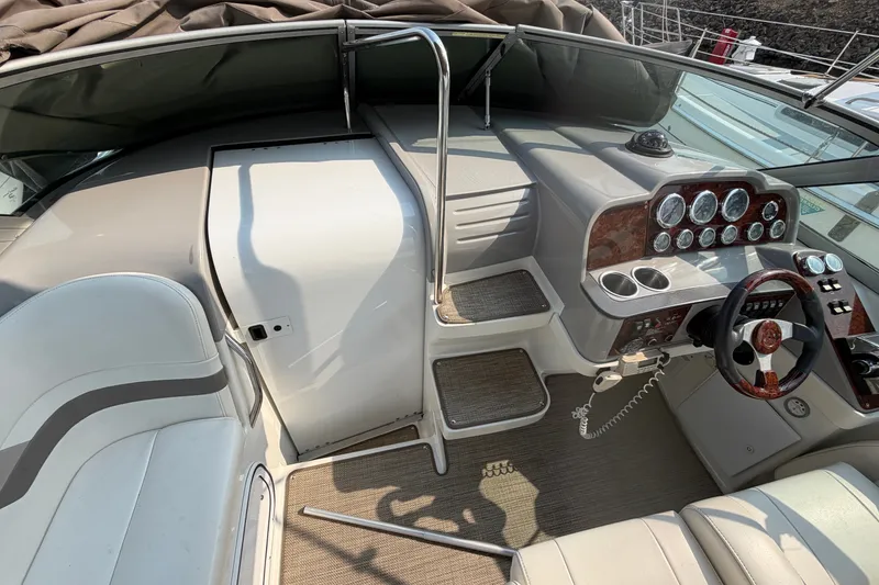 Slide: The Image of 2002 Formula 27 Performance Cruiser cockpit with steering wheel, gauges, and seating. - 11
