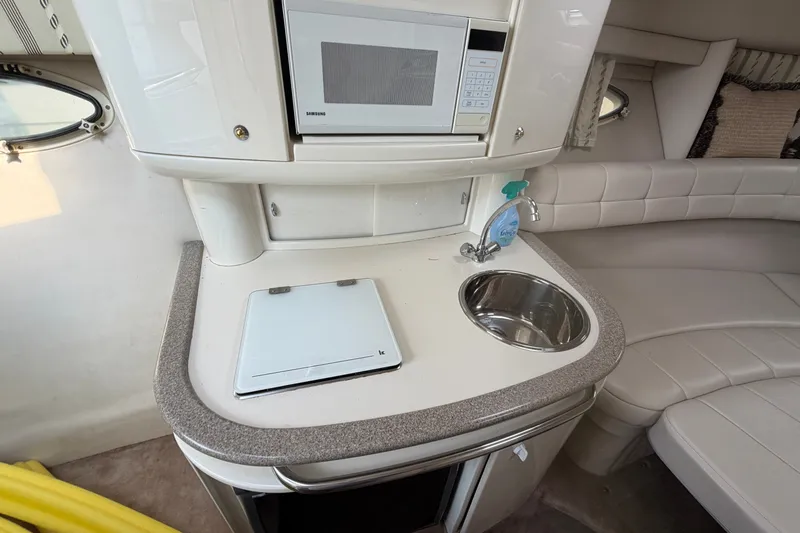 Slide: The Image of Interior of a 2002 Formula 27 Performance Cruiser with kitchenette and seating area. - 16