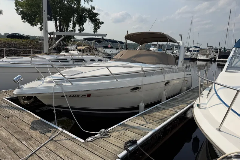 Slide: The Image of 2002 Formula 27 Performance Cruiser docked at marina, surrounded by other boats. - 2