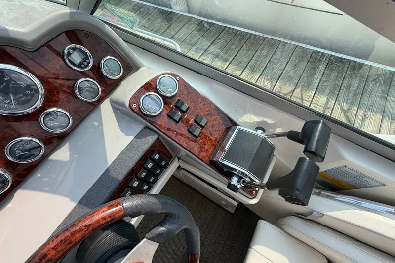 Slide: The Image of Dashboard of a 2002 Formula 27 Performance Cruiser with wood accents and control levers. - 13