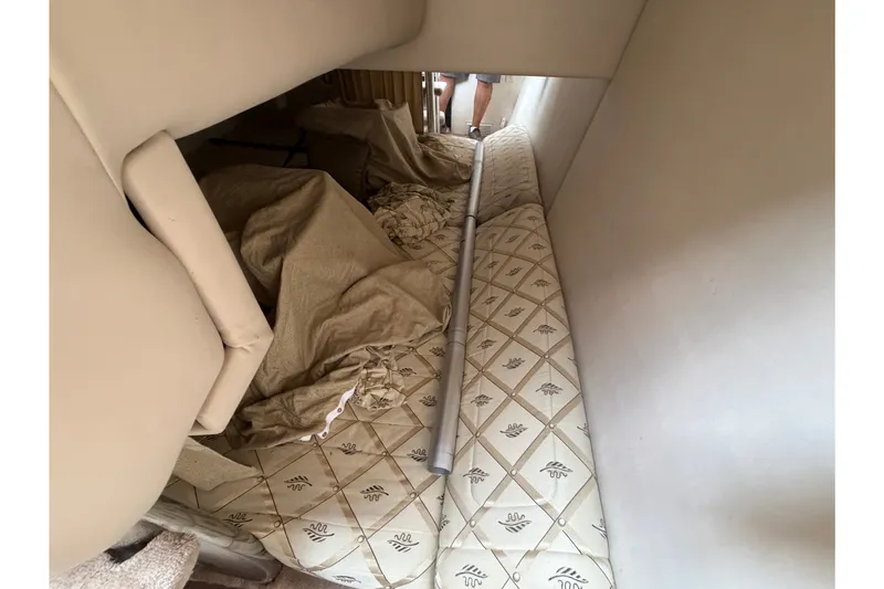 Slide: The Image of Interior of a 2002 Formula 27 Performance Cruiser with patterned upholstery and beige fabric. - 19