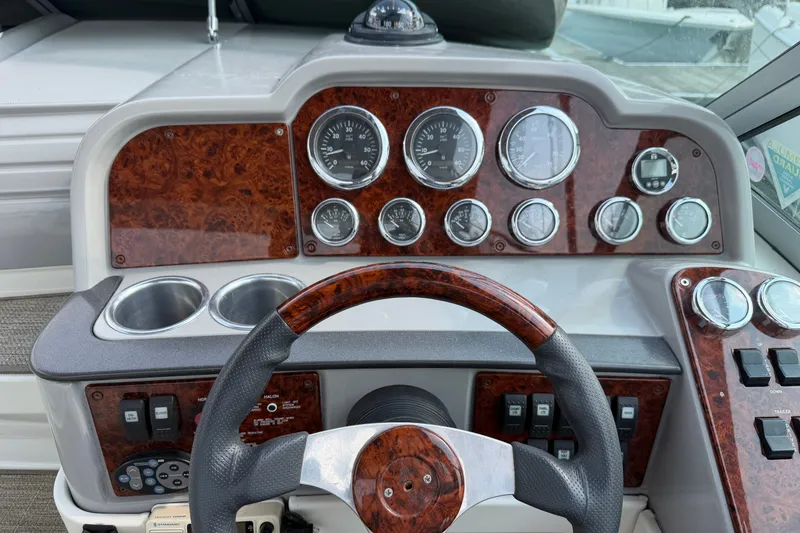 Slide: The Image of Dashboard of a 2002 Formula 27 Performance Cruiser with wood accents and gauges. - 6