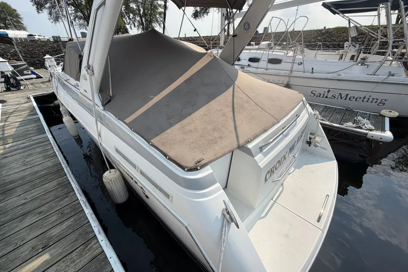Slide: The Image of 2002 Formula 27 Performance Cruiser docked, covered, with adjacent sailboats and wooden pier. - 4