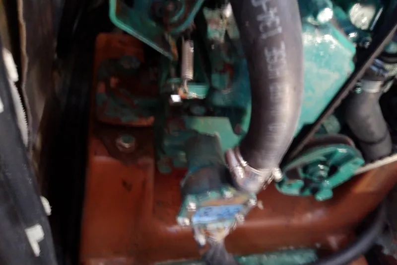 Slide: The Image of Engine compartment of a 2001 Bavaria Cruiser 37 sailboat, showing hoses and components. - 34