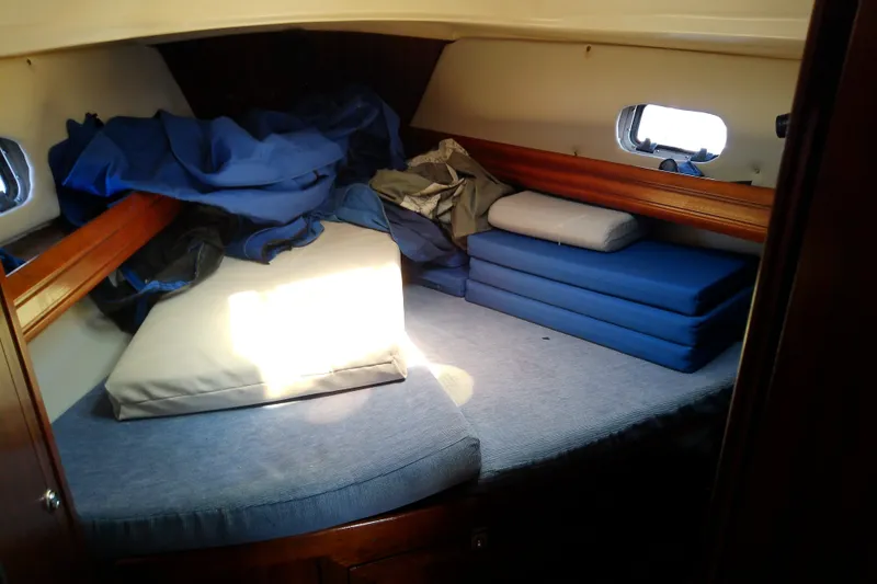 Slide: The Image of Cozy cabin interior of a 2001 Bavaria Cruiser 37 sailboat with cushions and bedding. - 40