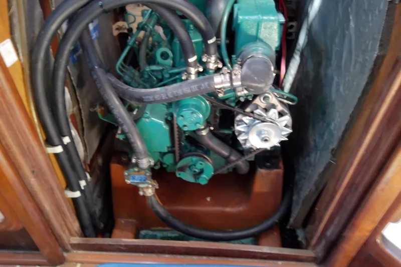 Slide: The Image of Engine compartment of a 2001 Bavaria Cruiser 37 sailboat, showcasing mechanical components. - 33
