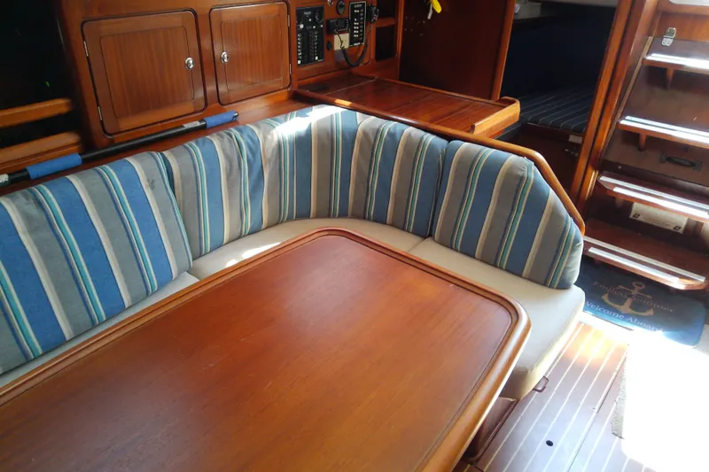Slide: The Image of Interior of 2001 Bavaria Cruiser 37 yacht with striped cushions and wooden table. - 27