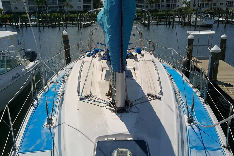 Slide: The Image of Sailboat Bavaria Cruiser 37, 2001 model, docked at marina with blue covers. - 7