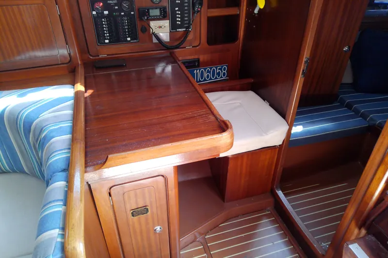 Slide: The Image of Interior of a 2001 Bavaria Cruiser 37 yacht with wooden cabinetry and striped seating. - 29