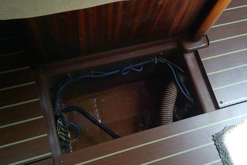 Slide: The Image of Open hatch on Bavaria Cruiser 37 yacht, revealing interior wiring and components. - 52