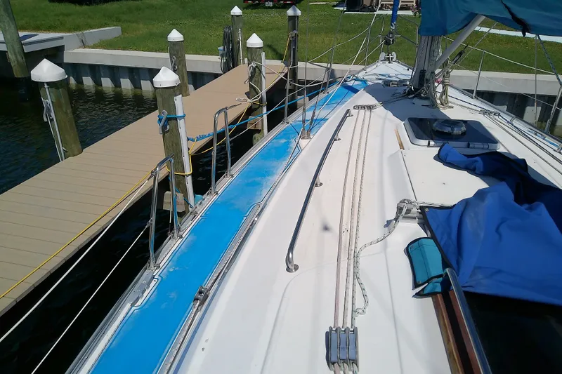 Slide: The Image of Bavaria Cruiser 37 sailboat docked, showcasing deck and rigging, 2001 model. - 16