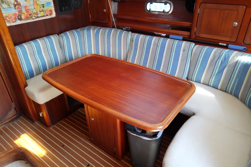 Slide: The Image of Interior of 2001 Bavaria Cruiser 37 yacht with striped seating and wooden table. - 26